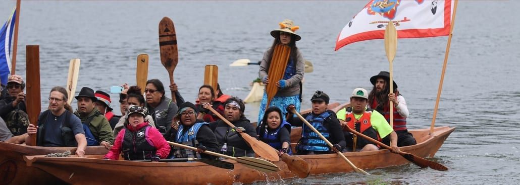 People in boats crossing a body of water